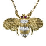 18K Yellow gold bee pendant has a brushed textured finish with 0.07 ctw diam and .02 ctw Rubies for eyes, on an 18 chain