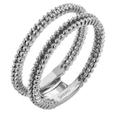 This wedding set features a white gold vintage inspired engagement ring in the center with a yellow gold granulated ring guard that provides a unique look.