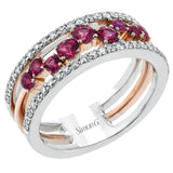 This ring features a meandering path of .65 ctw offset rubbies in it midst, flanked by .38 ctw white diamonds along the edges.