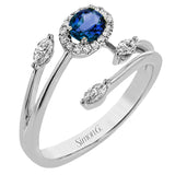 This delightful 18k gold ring is set with one .30 ctw sapphire and .06ctw of white round diamonds and .16ctw marquise diamonds in its bypass design