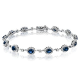 This 18K white gold bracelet features 2.68 ctw of oval sapphires each surrounded by white diamonds 1.42 ctw., 7
