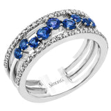 This ring features a meandering path of .65 ctw offset sapphires in it midst, flanked by .38 ctw white diamonds along the edges.