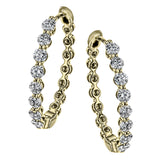 Dazzling yet refined, these yellow gold hoops showcase an impressive 1.51 ctw of white diamonds