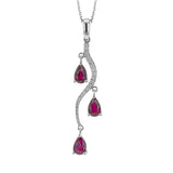 1.44 ctw of gorgeous ruby teardrops swing from this 18k white gold pendant, which is also set with .11 ctw of white diamonds.