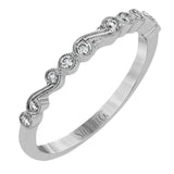 This vintage inspired 18k white gold ring contains .11 ctw of round white diamonds in a delicate swirling design. Perfect for stacking.