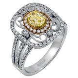 Reflecting an intricate vintage-inspired design, this three-tone gold ring is set with .61 ctw round cut white diamonds and a .53 ctw yellow oval diamond.