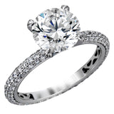 Presenting an eye-catching modern design, this white gold engagement ring and wedding band are highlighted by 1.45 ctw of round cut white diamonds.