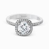 Accented by .46 ctw of glistening round cut white diamonds, this contemporary white gold halo style engagement ring and wedding band set makes a dramatic statement.
