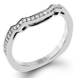Featuring an impressive modern design, this white gold ring features .53 ctw emerald cut stone sides and .46 ctw round cut white diamonds.