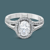 This lovely 18k white gold engagement ring design is created for an elegant oval center stone and features .77 ctw of white diamonds accented by a small touch of .03 ctw of yellow diamonds.