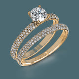 Reflecting a simple yet elegant classic design, this white gold engagement ring and band is accented by .86 ctw white diamonds.