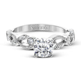 This remarkable set provides the looks of three rings, with a yellow gold ring guard set with yellow diamonds that encompasses the center white gold engagement ring.