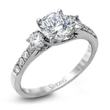 This classic three-stone engagement ring features .24 ctw of round brilliant side stones and .23 ctw of white diamonds extending down the sides.