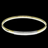 This lovely 18k yellow gold bangle contains .13 ctw of white diamonds in a simple line. This bangle is perfect for stacking, or making a delicate statement all on its own.